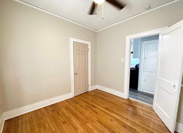 unfurnished room with crown molding, wood-type flooring, and ceiling fan