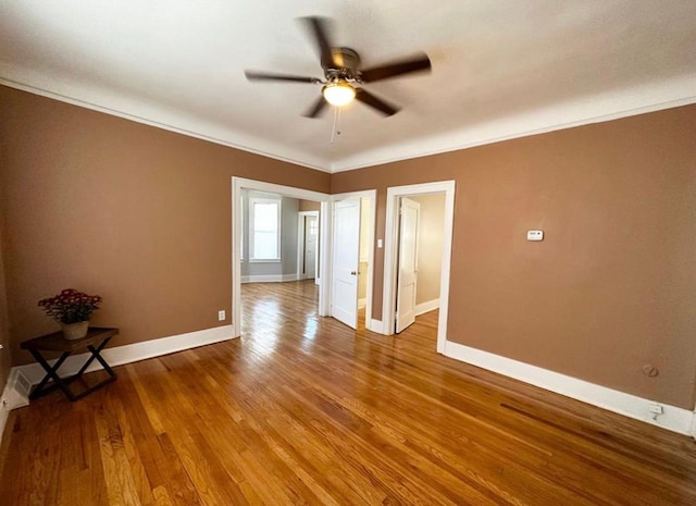 spare room featuring ceiling fan, ornamental molding, and hardwood / wood-style floors