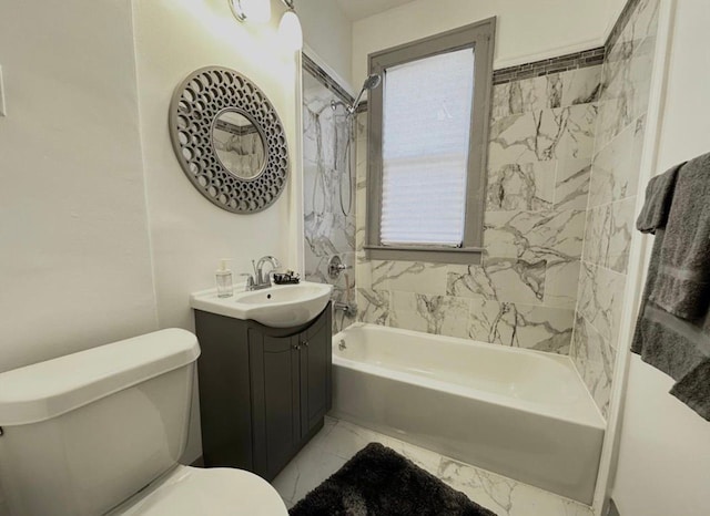 full bathroom with tiled shower / bath, vanity, and toilet