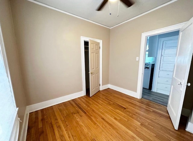 unfurnished bedroom featuring wood-type flooring, ornamental molding, and ceiling fan