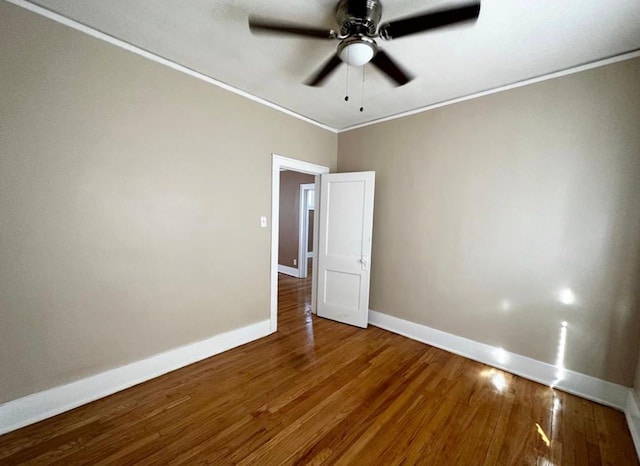 spare room featuring wood-type flooring, ceiling fan, and crown molding