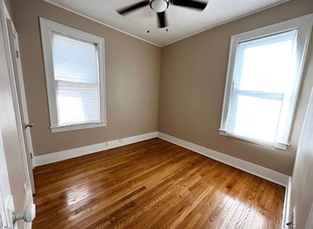 unfurnished room with hardwood / wood-style floors and ceiling fan