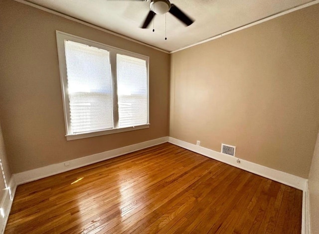 unfurnished room featuring ceiling fan, ornamental molding, and hardwood / wood-style floors