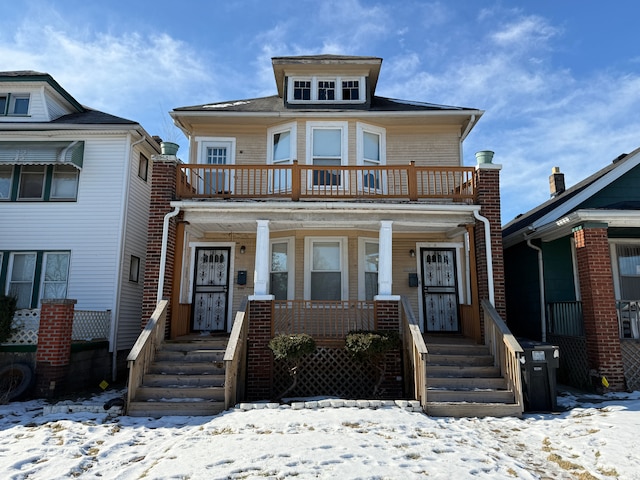 view of front of house with a balcony and covered porch