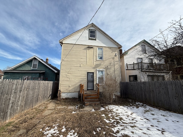 view of snow covered rear of property