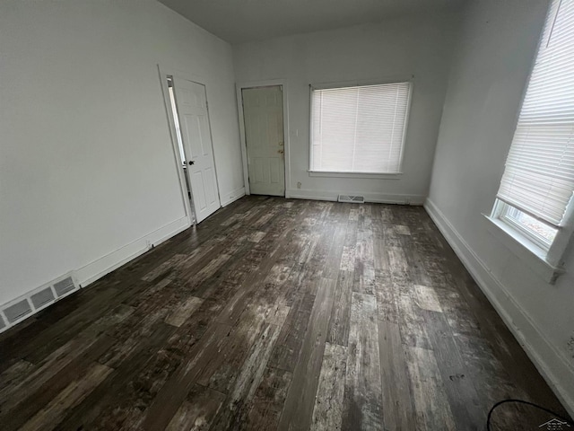 spare room with dark hardwood / wood-style floors