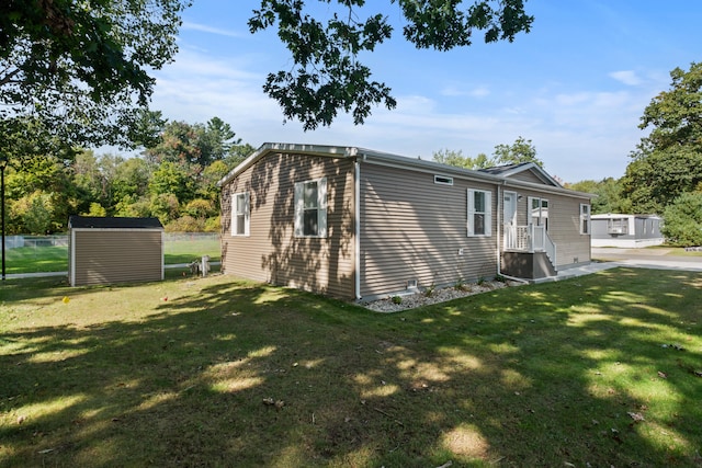 view of property exterior with a yard and a storage unit