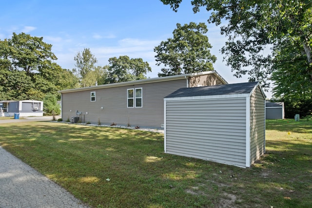 view of property exterior with a yard and a shed