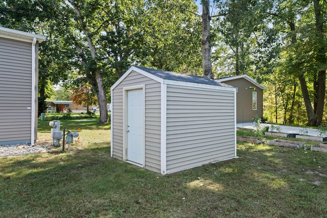 view of outdoor structure featuring a lawn