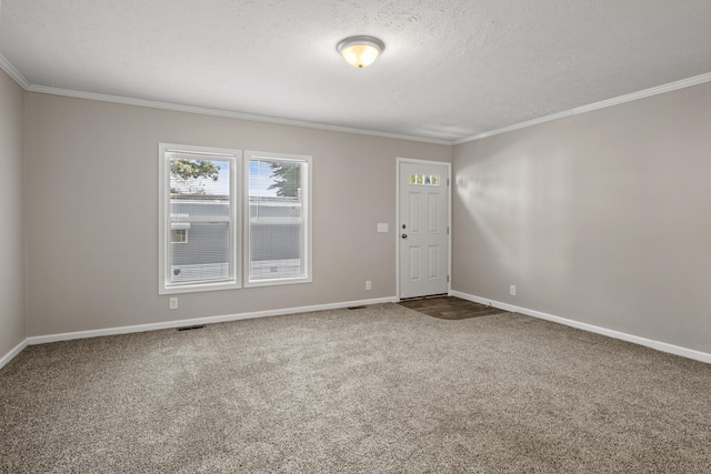 unfurnished room with carpet flooring, crown molding, and a textured ceiling