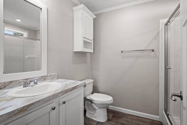 bathroom with an enclosed shower, toilet, hardwood / wood-style flooring, vanity, and ornamental molding