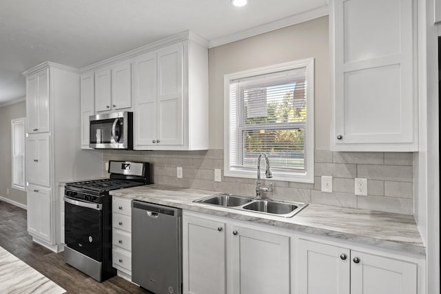 kitchen featuring white cabinetry, sink, dark wood-type flooring, stainless steel appliances, and crown molding