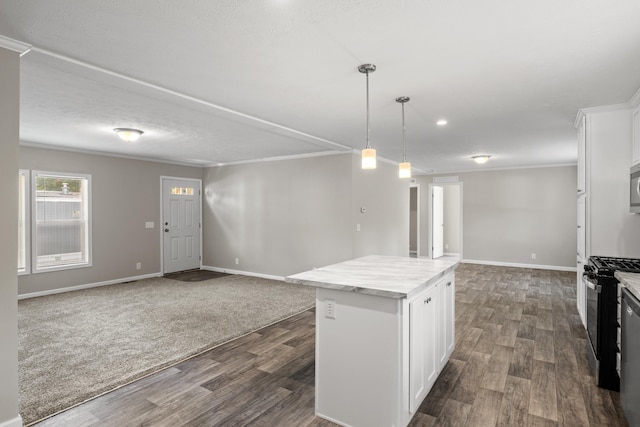 kitchen featuring a center island, stainless steel appliances, dark wood-type flooring, pendant lighting, and white cabinets