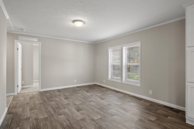 unfurnished room featuring a textured ceiling, wood-type flooring, and crown molding