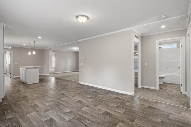 unfurnished living room with a textured ceiling, crown molding, and dark wood-type flooring