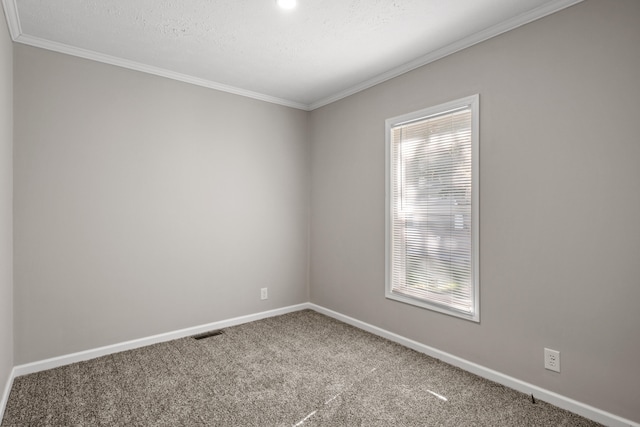 carpeted spare room with a textured ceiling and ornamental molding