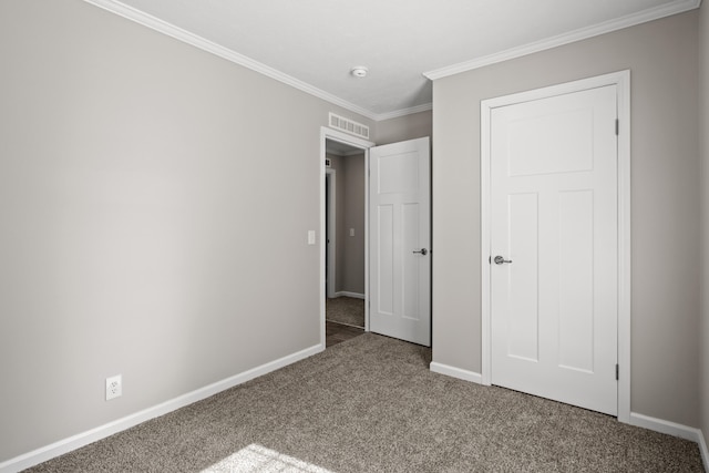 unfurnished bedroom featuring carpet floors and crown molding