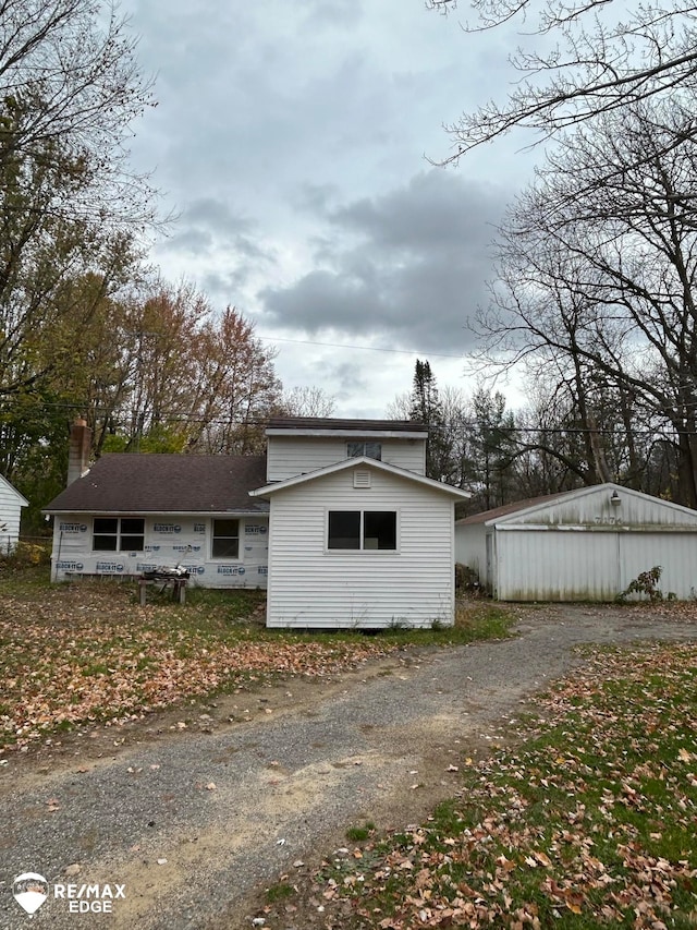 view of side of property featuring an outbuilding