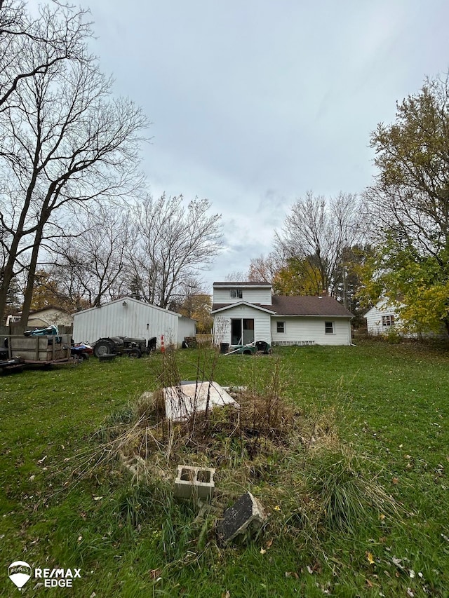 rear view of property with a lawn