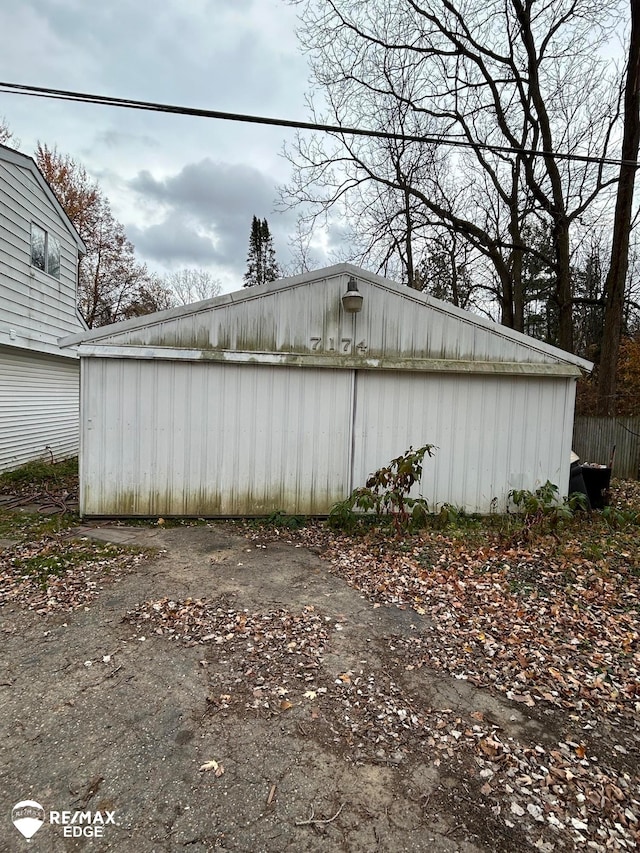 view of home's exterior with an outbuilding