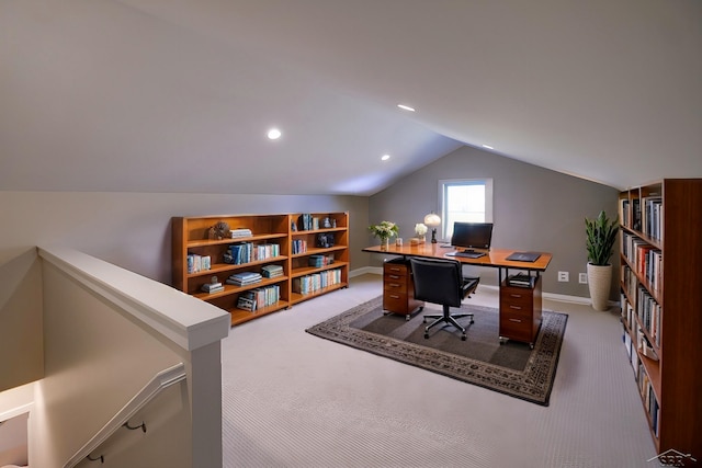 carpeted office with lofted ceiling