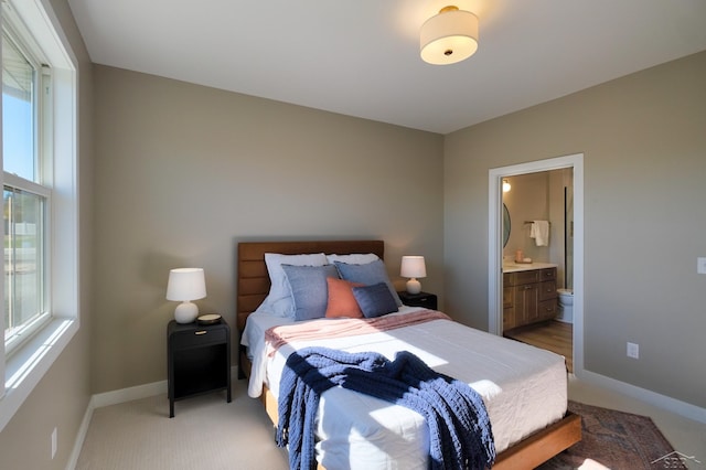 carpeted bedroom featuring connected bathroom