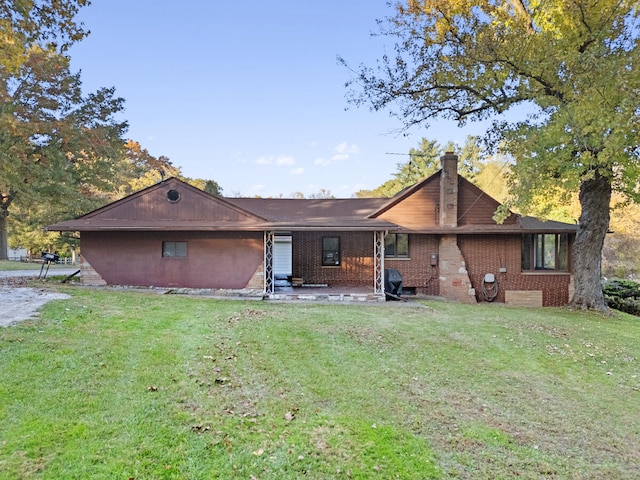 rear view of house featuring a lawn