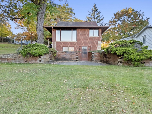 rear view of house with a yard