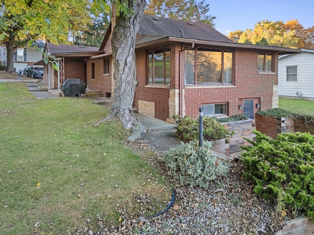 back of house with a lawn