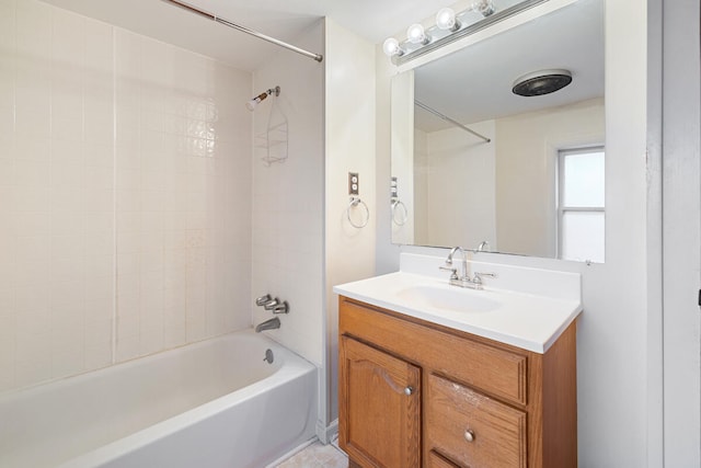 bathroom with vanity and tiled shower / bath