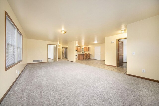 10376 Glencoe Rd, Jerome, MI 49249 - unfurnished living room featuring light carpet and baseboards
