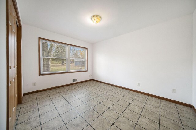 10376 Glencoe Rd, Jerome, MI 49249 - empty room featuring baseboards and light tile patterned flooring