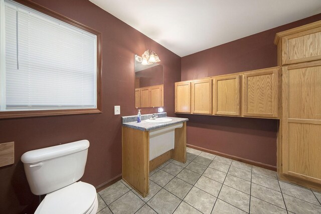 10376 Glencoe Rd, Jerome, MI 49249 - half bath featuring toilet, vanity, and tile patterned flooring