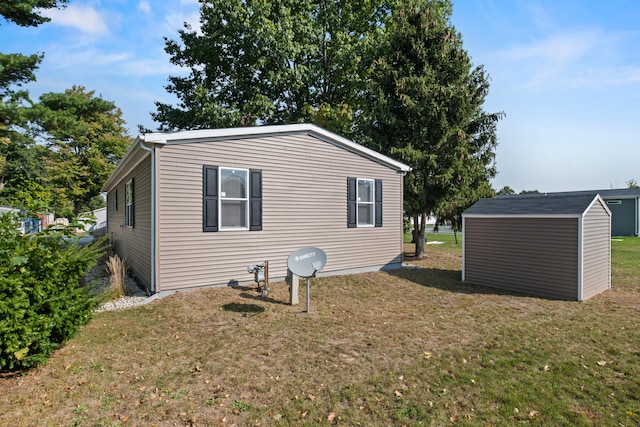 view of home's exterior with a storage shed and a yard