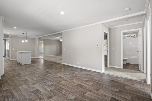 unfurnished living room featuring dark hardwood / wood-style flooring and ornamental molding