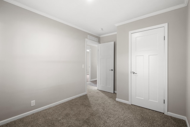 unfurnished bedroom with carpet and crown molding