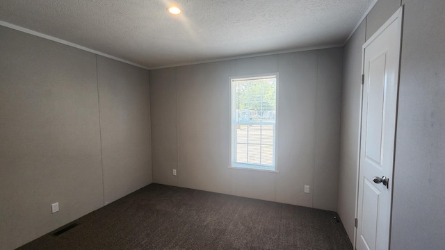 875 W Grand River Ave Unit 35, Williamston, MI 48895 - spare room with dark colored carpet, a textured ceiling, and crown molding
