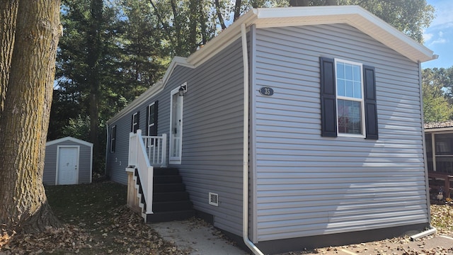 875 W Grand River Ave Unit 35, Williamston, MI 48895 - view of side of home with a storage shed