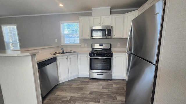 875 W Grand River Ave Unit 35, Williamston, MI 48895 - kitchen with appliances with stainless steel finishes, a peninsula, dark wood finished floors, white cabinets, and light countertops