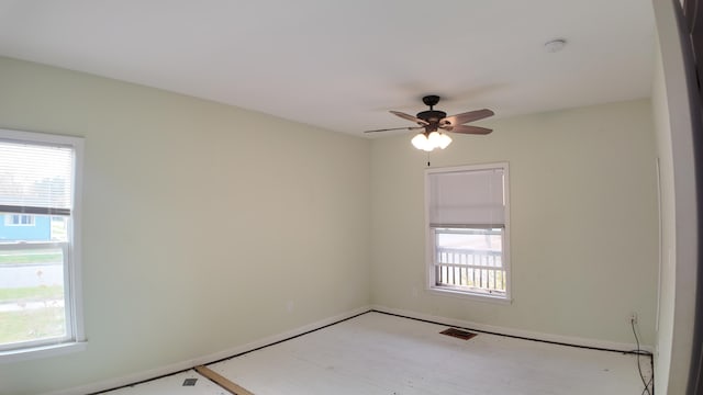 unfurnished room featuring ceiling fan and a healthy amount of sunlight