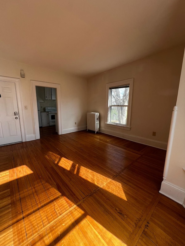 interior space with radiator heating unit and hardwood / wood-style flooring