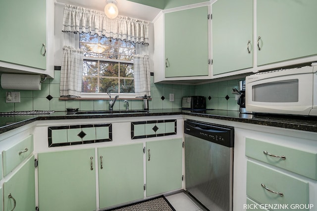4102 Highgate Rd, Norton Shores, MI 49441 - kitchen featuring tasteful backsplash, a sink, dark countertops, white microwave, and stainless steel dishwasher