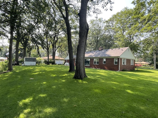 4102 Highgate Rd, Norton Shores, MI 49441 - view of yard featuring an outdoor structure and a storage unit