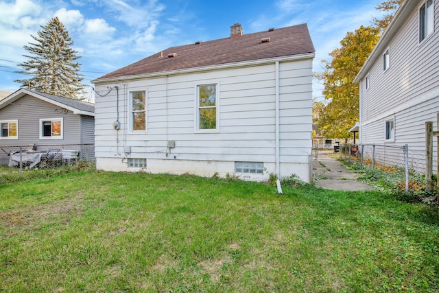 rear view of house with a yard