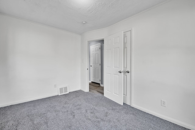 spare room with carpet floors and a textured ceiling