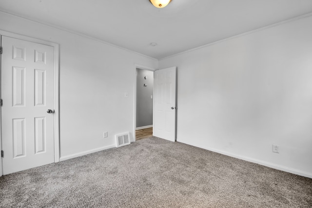 empty room with carpet floors and ornamental molding