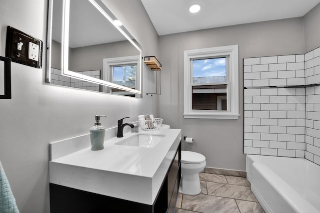 full bathroom with vanity, toilet, a wealth of natural light, and tiled shower / bath combo