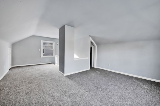 additional living space with carpet flooring and lofted ceiling