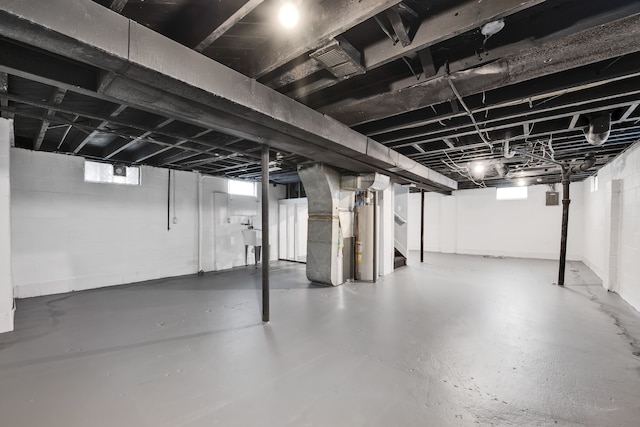 basement featuring heating unit and sink