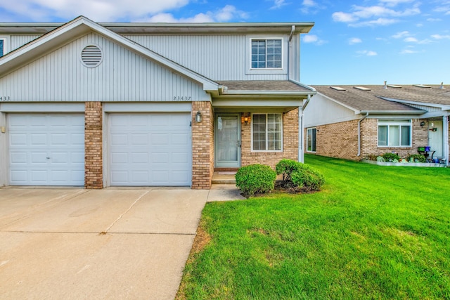 view of front of property with a front yard and a garage